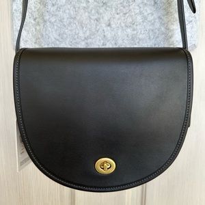 Coach turnlock saddle crossbody bag